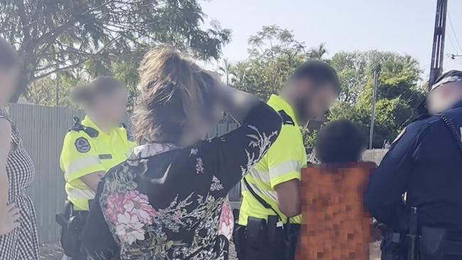 Police attempt to convince the 11-year-old boy to cooperate before he is wrestled into the paddy wagon.