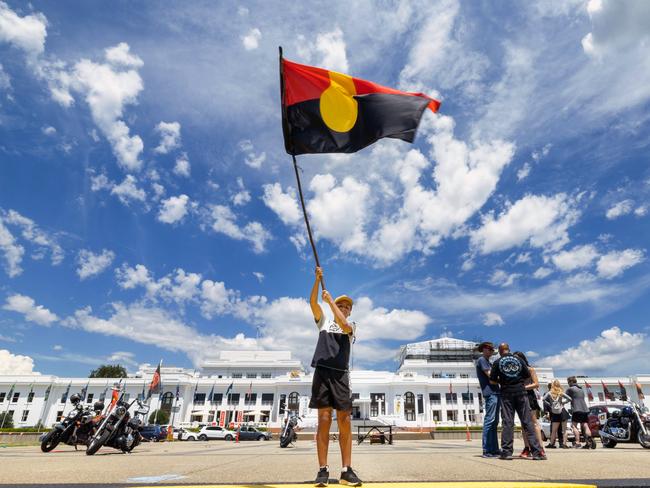 CANBERRA, AUSTRALIA - NewsWire Photos JANUARY 26, 2023: A small crowd gathered at the Aboriginal Tent Embassy, on the lawns of Old Parliament House, in Canberra to mark Invasion day. Ngunnawal boy, Tahlen Bell, 12 yers old, from Yass with the indigenous flag.Picture: NCA NewsWire / Gary Ramage