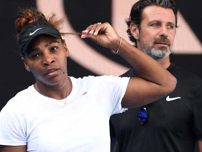 Serena Williams of the United States (left) is seen alongside her coach Patrick Mouratoglou as she practices  for the Australian Open on Margaret Court Arena in Melbourne, Saturday, January 12, 2019. (AAP Image/Julian Smith) NO ARCHIVING