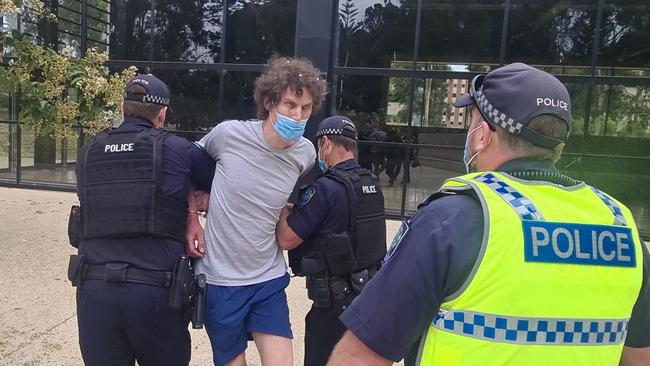 The man is led away by police. Picture: Andrew Hough