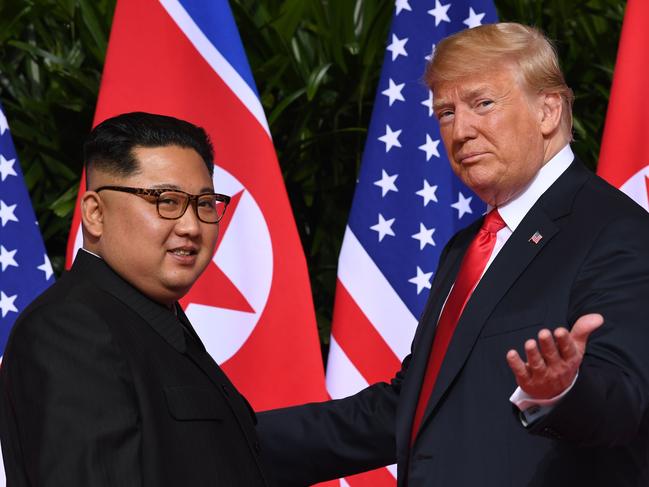 AFP presents a retrospective photo package of 60 pictures marking the 4-year presidency of President Trump.  US President Donald Trump (R) gestures as he meets with North Korea's leader Kim Jong Un (L) at the start of their historic US-North Korea summit, at the Capella Hotel on Sentosa island in Singapore on June 12, 2018. - Donald Trump and Kim Jong Un have become on June 12 the first sitting US and North Korean leaders to meet, shake hands and negotiate to end a decades-old nuclear stand-off. (Photo by SAUL LOEB / AFP)