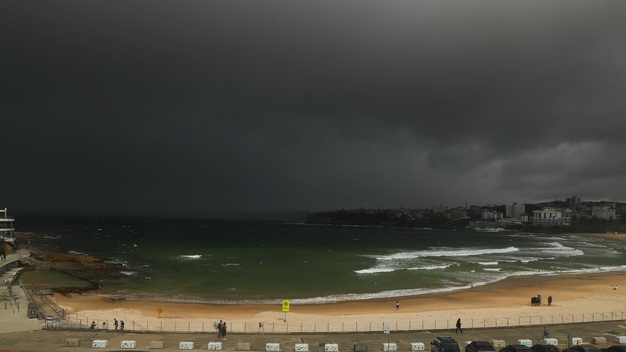 A squall comes ashore at Bondi dropping heavy rain sending people running on Thursday morning. Picture: John Grainger