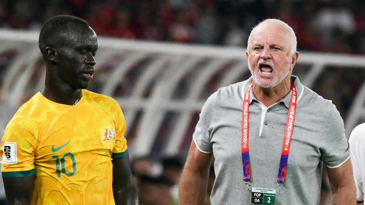 Australia's coach Graham Arnold (C) reacts to the referee as Australia's Awer Mabil (L) and Indonesia's Calvin Verdonk (R) wait during the 2026 FIFA World Cup Asian qualification football match between Indonesia and Australia at Gelora Bung Karno Stadium in Jakarta on September 10, 2024. (Photo by ADITYA AJI / AFP)