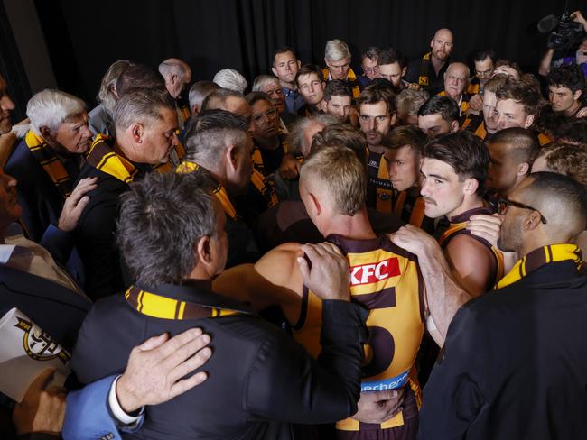 Sam Mitchell, senior coach of Hawthorn talks with players past and present moments before the team run onto the MCG. Picture: Michael Klein