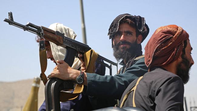 Taliban fighters stand guard in a vehicle along the roadside to Kabul. Picture: AFP