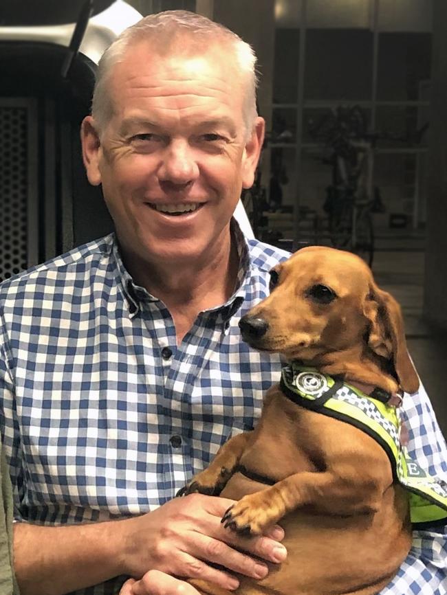 Police Commissioner Grant Stevens with his dog Gracie, a member of the SAUSAGE Squad.