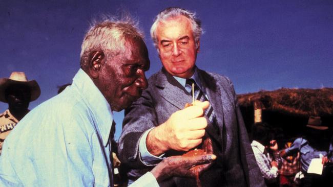 Former Prime Minister Gough Whitlam pours sand into the hand of Vincent Lingiari during a 1975 ceremony marking handover of traditional Gurindji land at Wave Hill.