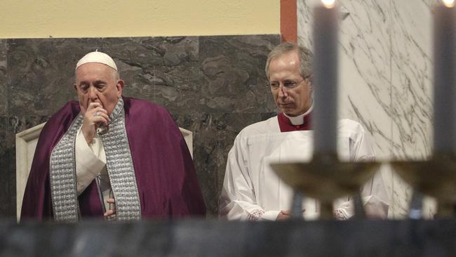 Pope Francis coughs inside the Basilica of Saint Anselmo prior to the start of a procession to the Basilica of Santa Sabina before the Ash Wednesday Mass opening Lent.