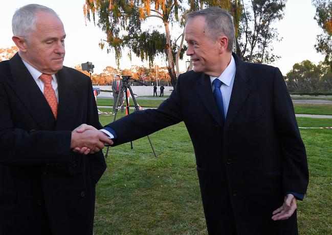 Who’s fault? Australian Prime Minister Malcolm Turnbull (left) and Australian Opposition Leader Bill Shorten shake hands as they arrive for early morning TV interviews outside Parliament House on Wednesday. Picture: Lukas Coch/AAP