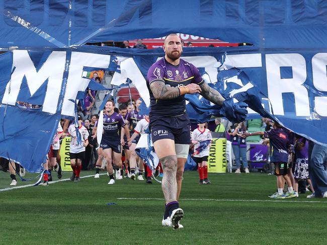 Nelson Asofa-Solomona of the Storm runs through the banner for his 200th game. Picture: Daniel Pockett/Getty Images