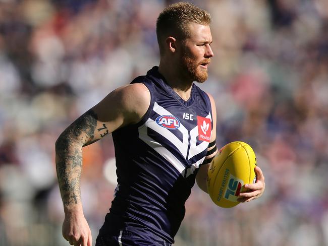 PERTH, AUSTRALIA - MARCH 24: Cam McCarthy of the Dockers jogs back for a kick on goal during the round one AFL match between the Fremantle Dockers and the North Melbourne Kangaroos at Optus Stadium on March 24, 2019 in Perth, Australia. (Photo by Paul Kane/Getty Images)