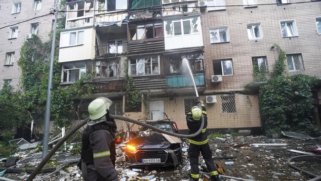 Firefighters tackle a blaze after a Russian attack that hit a residential building in Kharkiv. Picture: AP