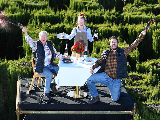 Maxwell wineries owner Mark Maxwell and son and general manager Jeremy Maxwell celebrate the re- opening of the Fleurieu with cellar door Katie Whish on a platform dining above their maze Friday May 29,2020.Picture Mark Brake