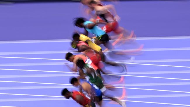 TOPSHOT - Athletes competes in the men's 100m heat of the athletics event at the Paris 2024 Olympic Games at Stade de France in Saint-Denis, north of Paris, on August 3, 2024. (Photo by Kirill KUDRYAVTSEV / AFP)