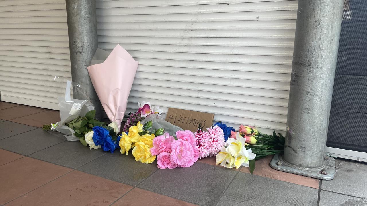 Mourners laid flowers and a sign stating #LifeMatters outside the Alice Spring Coles after being restrained by police on Wednesday May 27. Picture: Gera Kazakov