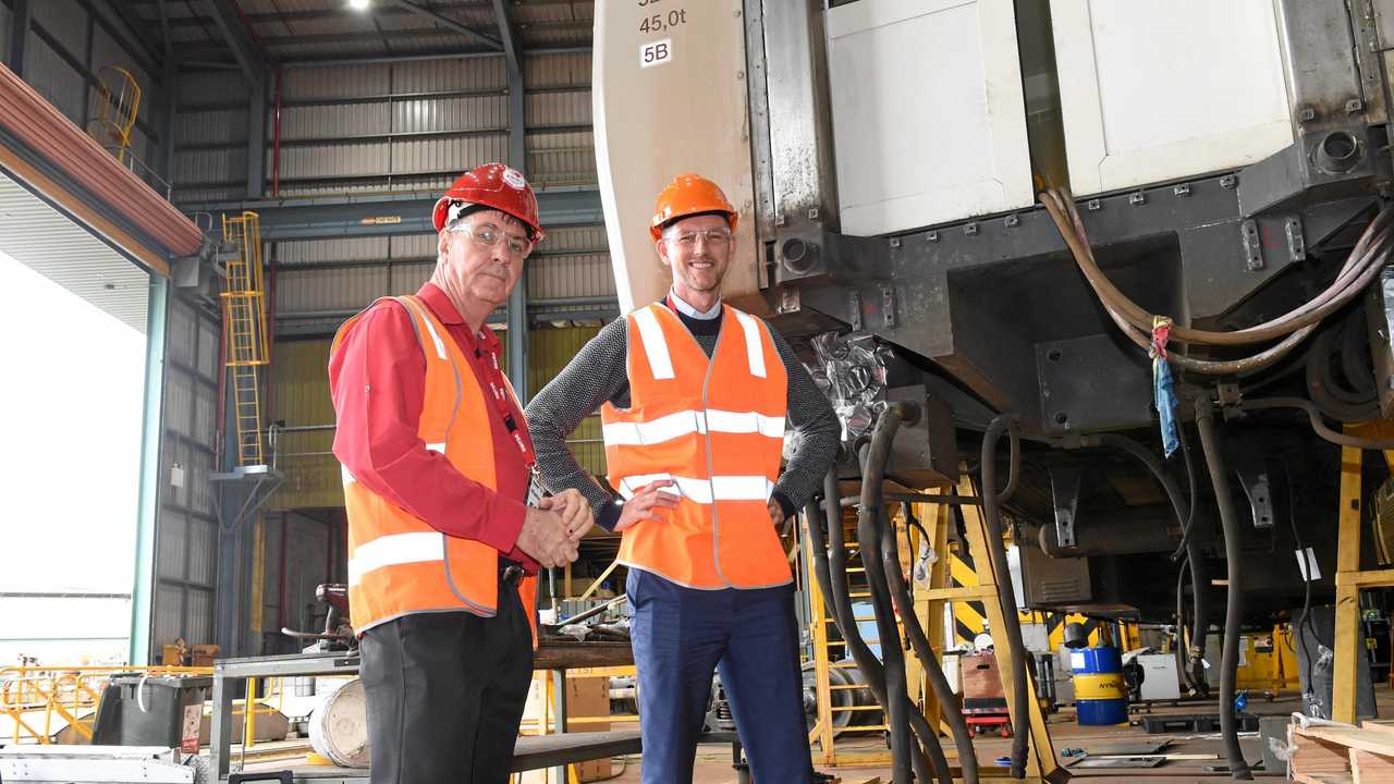 RAIL RALLY: MP Bruce Saunders with transport minister Mark Bailey at Maryborough's Downer factory. Picture: Blake Antrobus