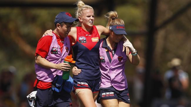 Shae Sloane is helped from the field after injuring her knee in Round 1.