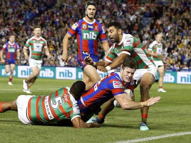 Lachlan Fitzgibbon crashes over for the Knights against South Sydney. Picture: AAP