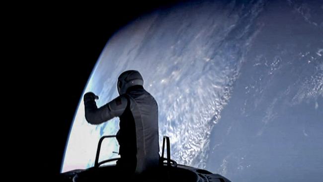 US fintech billionaire Jared Isaacman peeking out to space from a hatch structure called "Skywalker", during the first private spacewalk performed by the crew of the SpaceX Polaris Dawn mission.