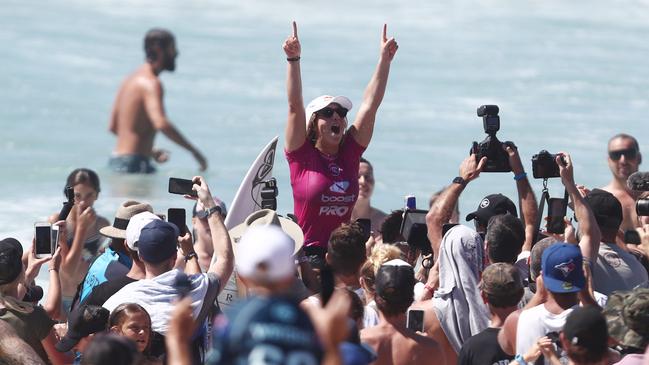 Teenager Caroline Marks is chaired along the beach. Picture: Getty