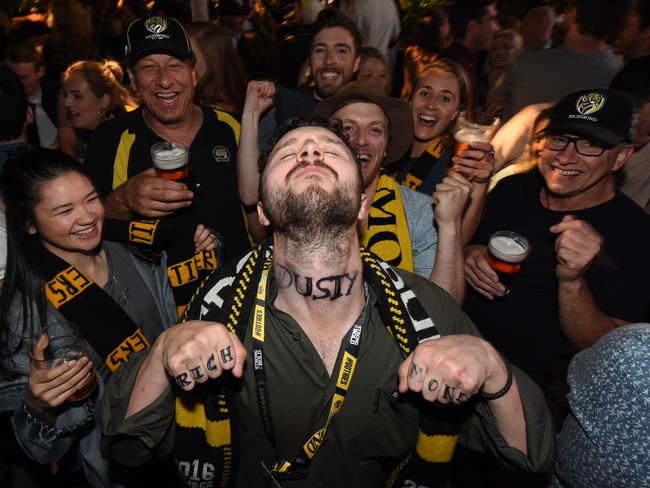 Tigers supporter Fraser Cameron showing off his fake Dusty neck tattoo at the Corner Hotel after the Richmond victory. Picture: Tony Gough