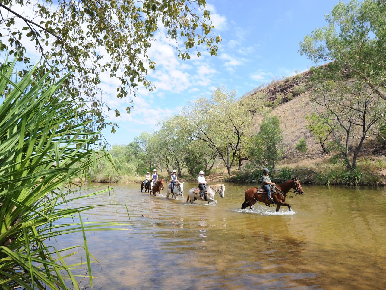 Ranger Katanya taking a group on a horse trek.