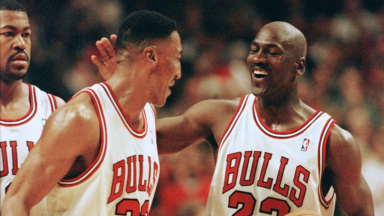 Michael Jordan (R) of the Chicago Bulls celebrates with teammate Scottie Pippen (L) after Pippen had a block against Kendal Gill of the New Jersy Nets 24 April late in the second half of their first round play-off game at the United Center in Chicago, IL. The Bulls won the 96-93 in overtime to take a 1-0 lead in the five game series. AFP PHOTO/Jeff HAYNES (Photo by JEFF HAYNES / AFP)