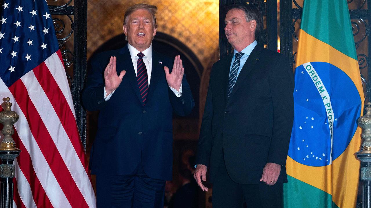 Brazilian President Jair Bolsonaro's press secretary tested positive for coronavirus days after taking part in meetings with US President Donald Trump at Mar-a-Lago, Florida. Picture: Jim Watson / AFP.