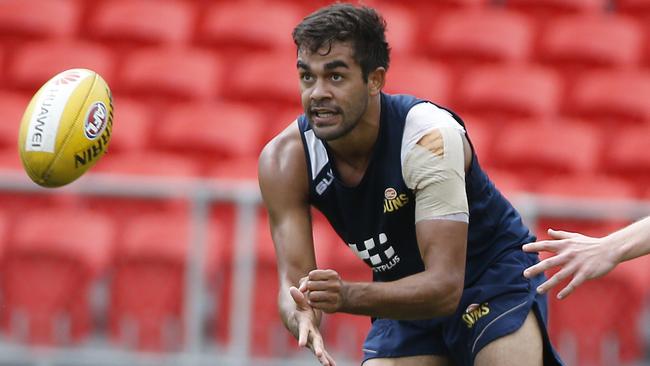 Jack Martin fires off a handball at Gold Coast training. Picture: Jerad Williams