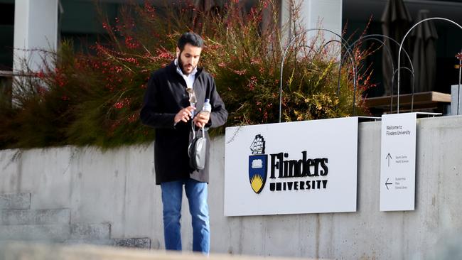 A man walks past Flinders University at Bedford Park in Adelaide, South Australia. Picture: NCA NewsWire / Kelly Barnes