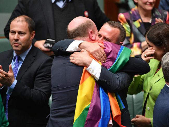 Liberal Member for North Sydney Trent Zimmerman and Liberal Member for Goldstein Tim Wilson celebrate the passing of the Marriage Amendment Bill in the House of Representatives at Parliament House in Canberra, Thursday, December 7, 2017. (AAP Image/Mick Tsikas) NO ARCHIVING