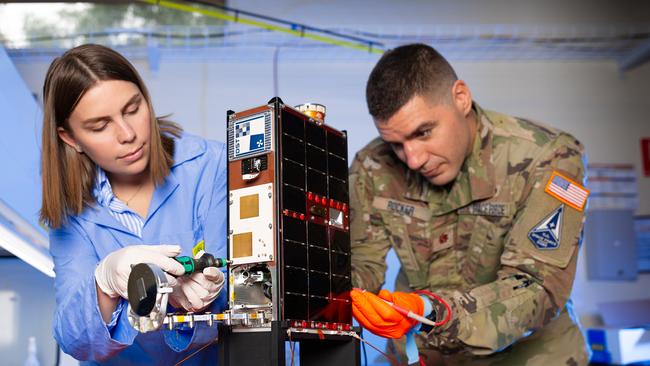 Scientists Franke Agenbag and US Major Chris Rocker with the Buccaneer CubeSat, the first sovereignly developed Defence satellite program flown by Australia since WRESAT (Weapons Research Establishment Satellite) in 1967. Picture: Department of Defence