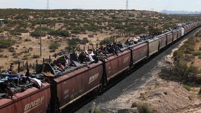 Venezuelans ride a goods train through Mexico this week. Picture: AFP