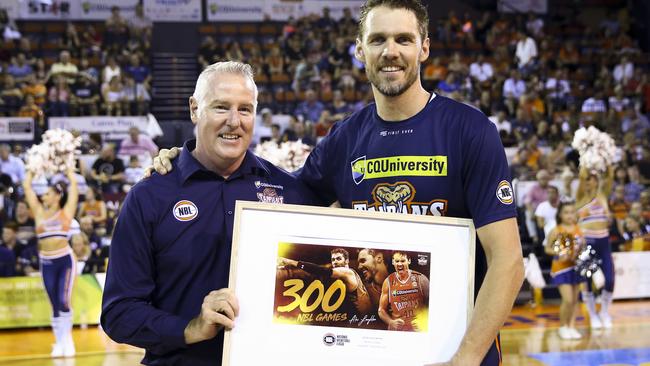 Alex Loughton of the Cairns Taipans (right) is presented with a plaque commemorating his 300th Game by Taipans CEO Mark Beecroft (left) in 2019. (AAP Image/Dave Acree)