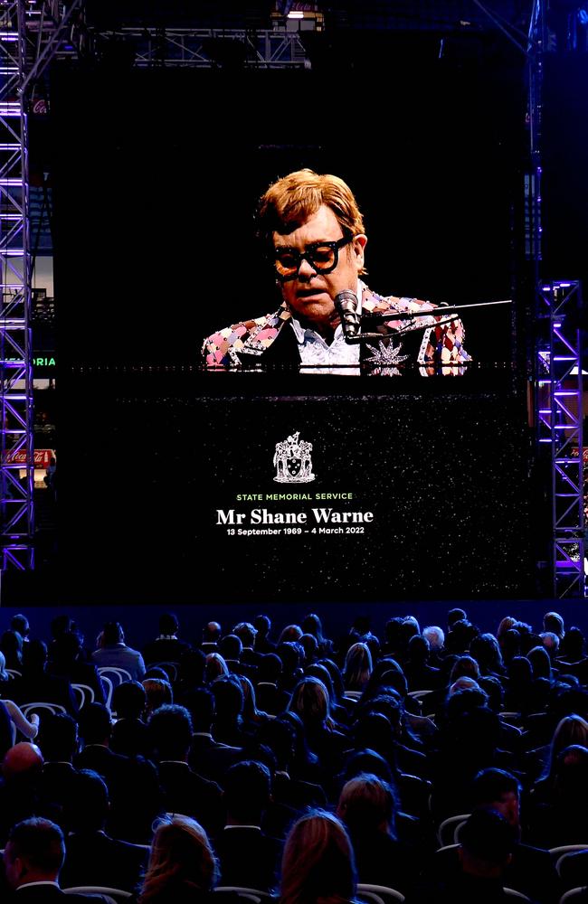 Elton John on the big screen at the MCG, performed in the US in tribute to his mate, Shane Warne. Picture: AFP