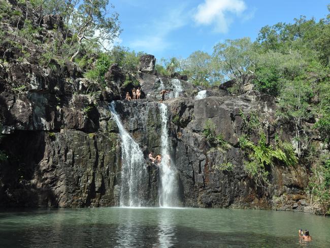 Daredevils jump off rock ledges at Cedar Creek Falls. 