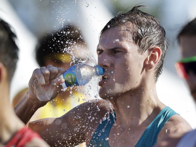 Dane Bird-Smith, of Australia, splashes himself with water on his way to a bronze medal in the Mens 20 K race walk at the 2016 Summer Olympics in Rio de Janeiro, Brazil, Friday, Aug. 12, 2016. (AP Photo/Robert F. Bukaty)