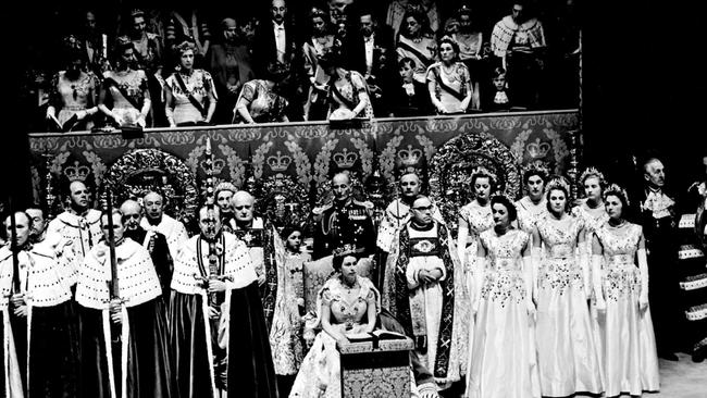 Prince Charles, standing between the Queen Mother and Princess Margaret, disappears for a moment, behind the canopied stand from which the Royal relations watch Queen Elizabeth II, her Maids of Honour and the Peers.