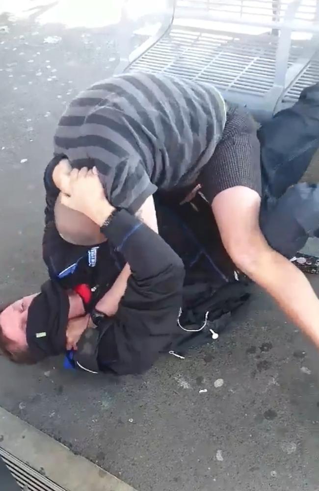 The footage starts recording with both men on the ground.