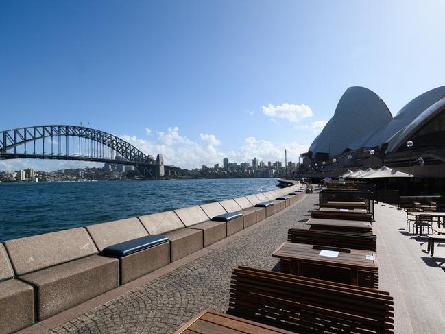 Empty tables at the Opera Bar in Sydney as tourists and locals stay away from the city on Saturday, March 21. Picture: AAP/James Gourley