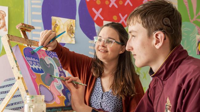 Local artist Alex Stalling shares her passion and expertise with George Storie. Deaf and hard of hearing teenagers will learn how to communicate artistically in a workshop designed to develop their creativity. Picture: Nev Madsen.