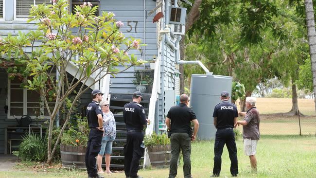 Police explain the scenario to residents at Nudgee Beach on Wednesday. Picture: Annette Dew