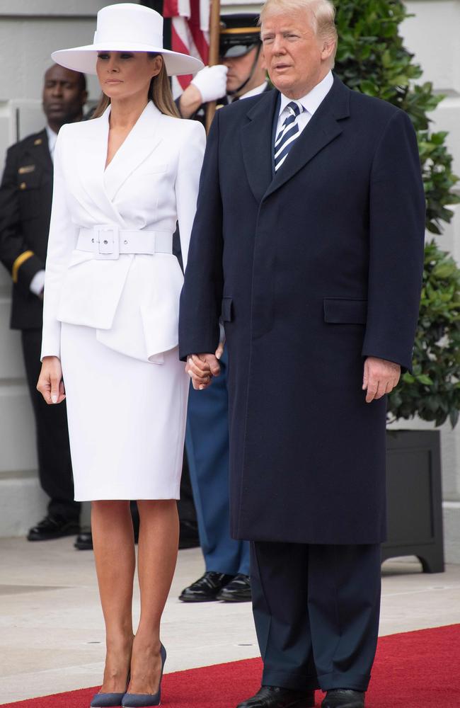 The US President eventually managed to persuade his wife to hold his hand. Picture: AFP/Jim Watson