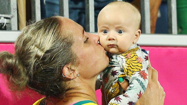 GOLD COAST, AUSTRALIA - APRIL 09:  Australia defender Edwina Bone kisses a baby during Hockey on day five of the Gold Coast 2018 Commonwealth Games at Gold Coast Hockey Centre on April 9, 2018 on the Gold Coast, Australia.  (Photo by Michael Dodge/Getty Images)