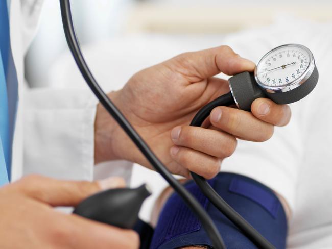 Close-up of doctor taking blood pressure of patient