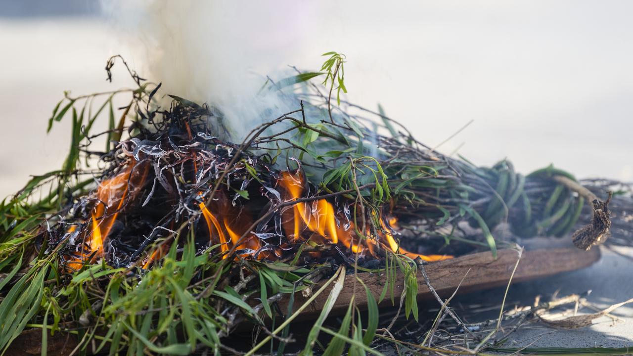 A coolamon and burning leaves are seen at a Smoking Ceremony at the NAIDOC arts and craft market at Grand Central, Saturday, July 9, 2022. Picture: Kevin Farmer