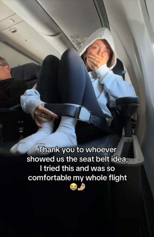 She can be seen in a viral clip bucking her seatbelt around her ankles to help make long haul flights ‘more comfortable’. Picture: TikTok/abbybaffoe