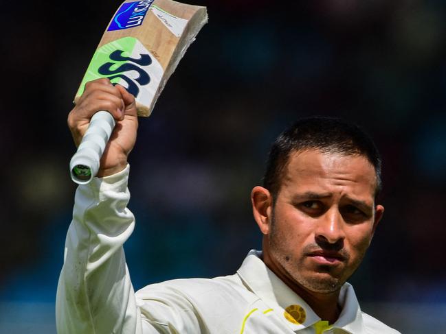 Australia's Usman Khawaja waves his bat as he walks back to the pavilion after his dismissal during the second day of the second Test cricket match between Pakistan and Australia at the National Cricket Stadium in Karachi on March 13, 2022. (Photo by ASIF HASSAN / AFP)