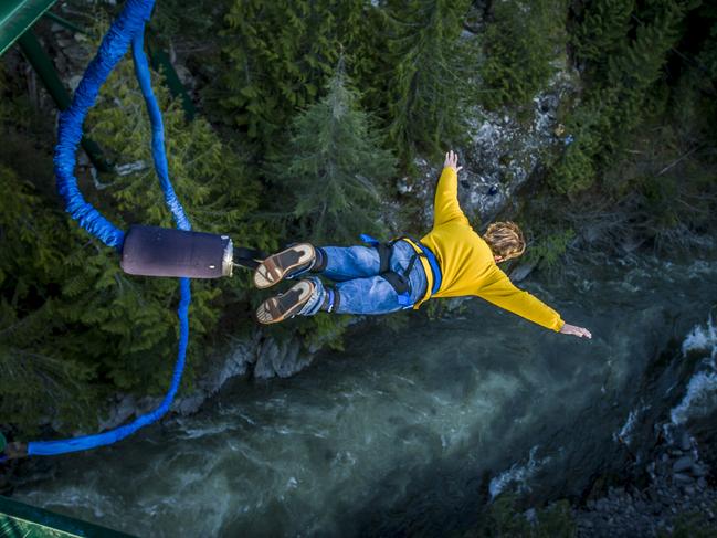 Young man bungee jumping over river.Escape 16 June 2024NewsPhoto - iStock