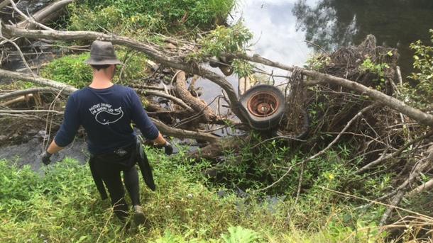 A volunteer picking out debris from the creek. Picture: supplied